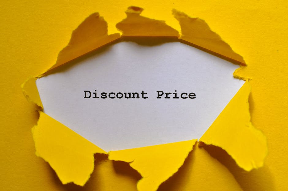 A close-up image of a piece of bright yellow paper torn open, revealing a white inner surface with the words 'Discount Price' printed in black typewriter-style font. The torn edges are uneven and jagged, creating a sense of dynamic texture between the yellow exterior and the smooth white interior. The background of the image is the same yellow paper, extending beyond the torn edges, giving the impression that the paper was ripped from a larger sheet. The lighting in the image is even, highlighting the contrast between the vivid yellow and stark white, with subtle shadows cast by the torn edges adding depth to the scene. This visual presents an abstract concept of a discount or special offer, with a focus on the torn paper highlighting an idea of surprise or revelation—elements relevant to promotional waste management or clearance services that emphasize quick, on-site alternative disposal solutions by Rubbish Removal Merton, captured here in a simple yet striking manner.